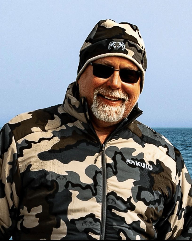 Jeff Meyerl, Chapter Treasurer, in a camouflage jacket and cap