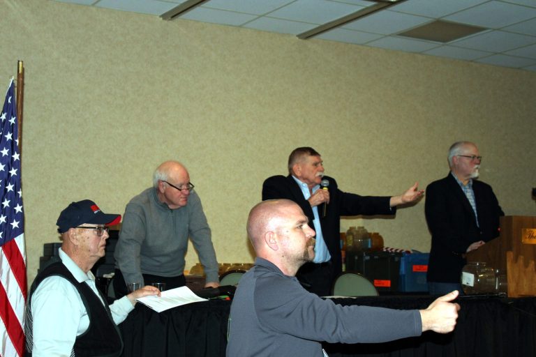 Auctioneer and spotters working the live auction